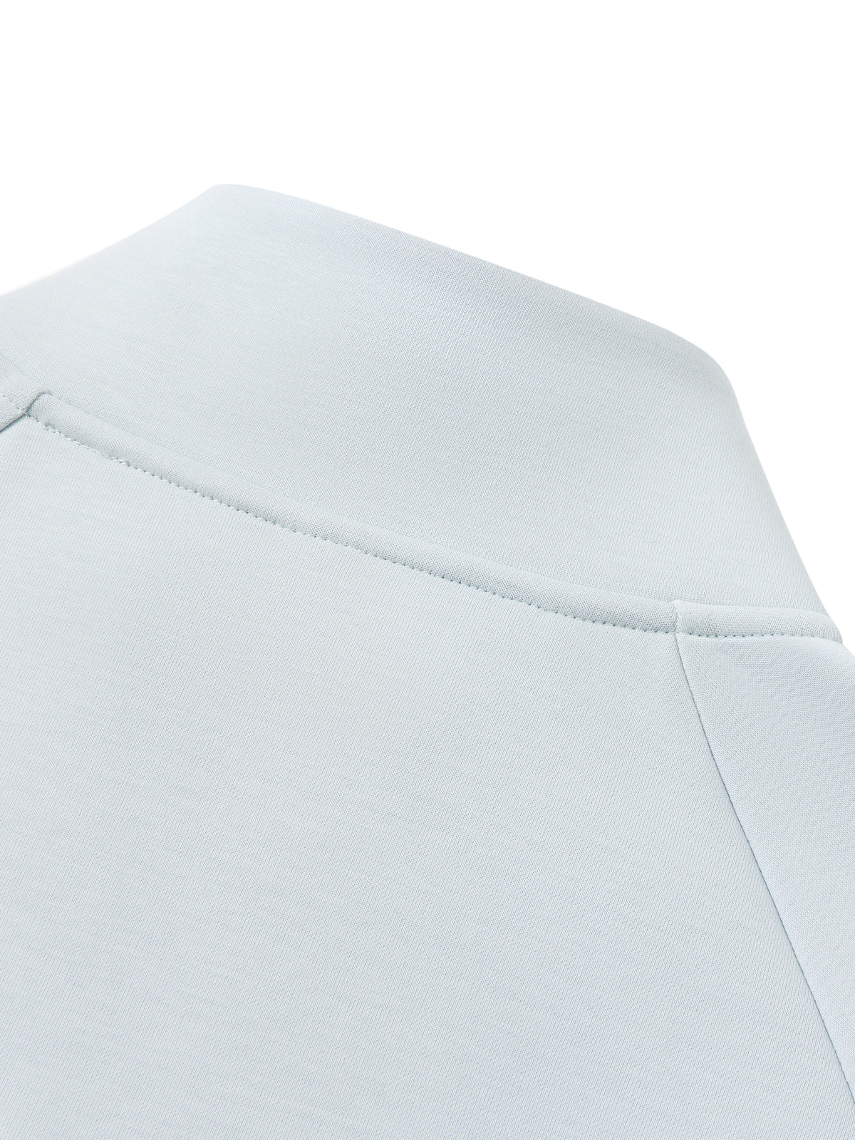 Light blue jacket shoulder and collar seam with partial zipper line