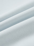 Light blue jacket fabric close-up with fine, smooth woven texture