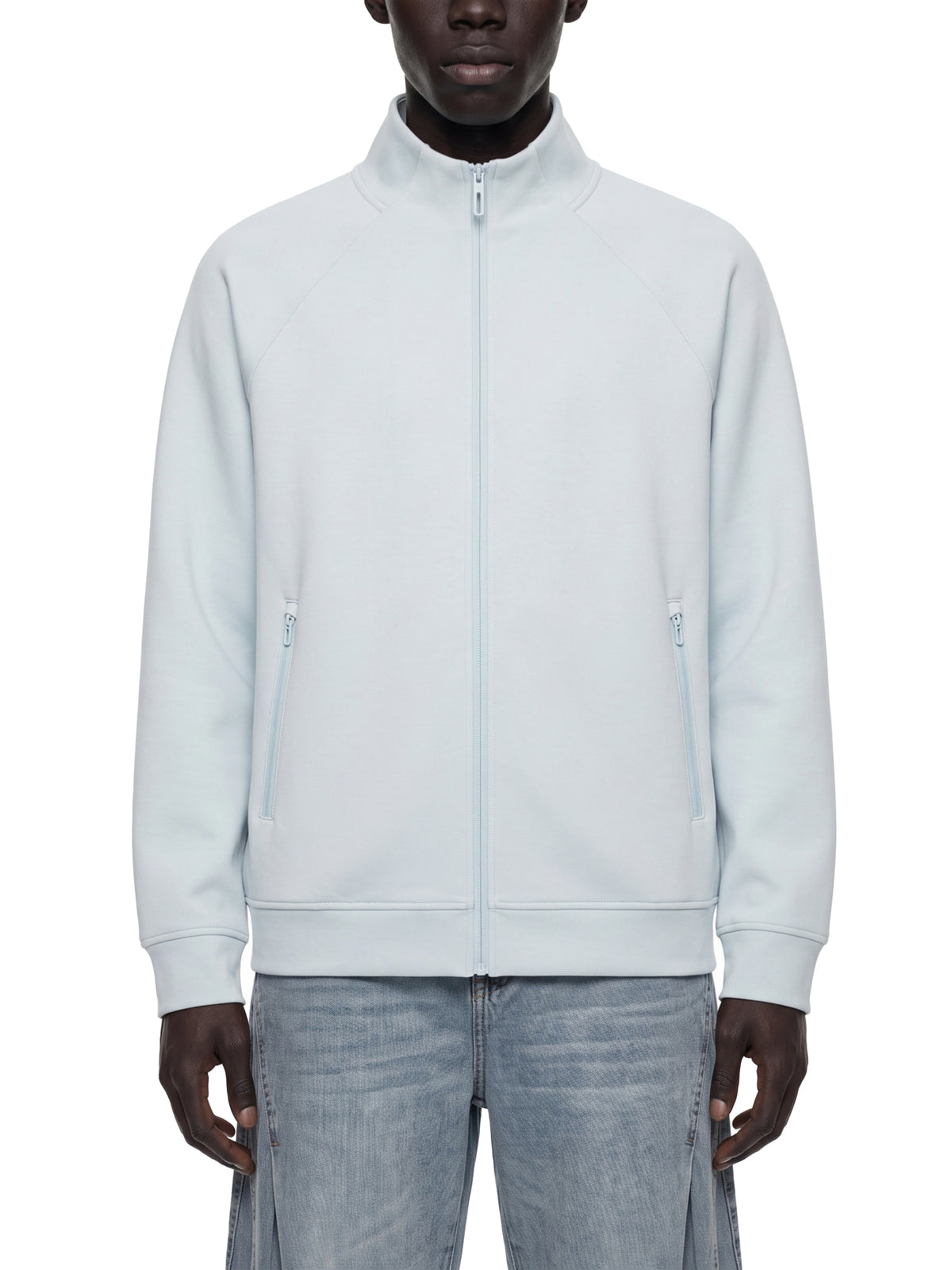 Pale blue stand collar zip jacket worn over jeans, front view with two side pockets.