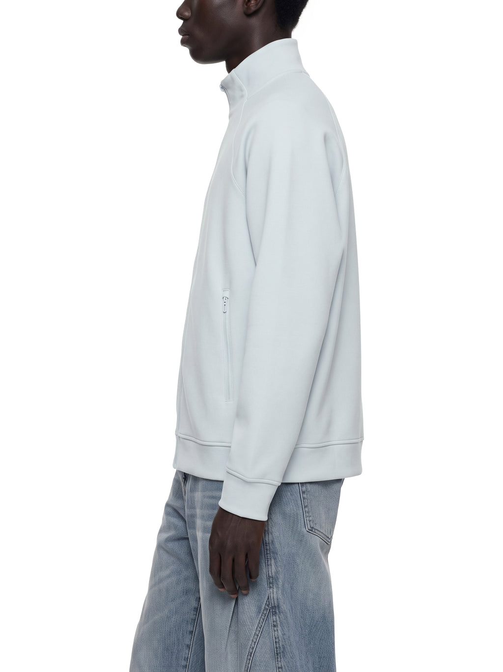 Pale blue stand collar zip jacket worn from the side, long sleeves and front zip.