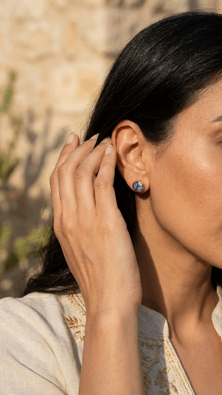 Small gold opal stud earrings with purple and blue iridescent stones