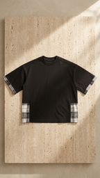 Unisex black plaid-paneled T-shirt laid flat, showing plaid cuff trim on sleeves