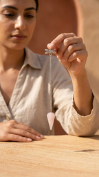 Rose quartz pendulum bag charm dangling from chain, pink teardrop stone and silver top