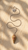 Unakite stone dowsing pendulum with long silver chain and clover connector