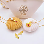 Gold choker necklace with pearl and shell charms plus sea-animal pendants