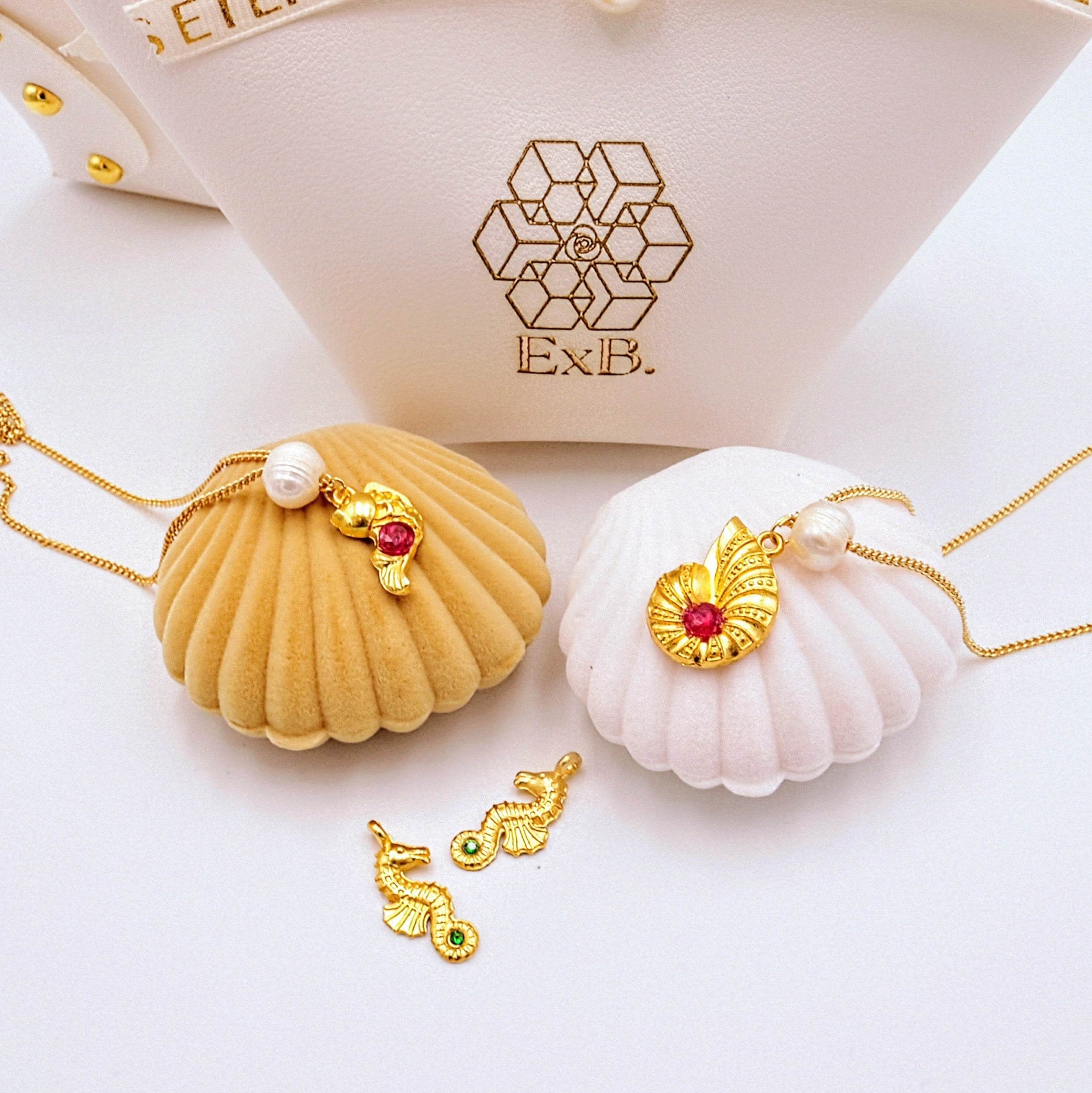 Gold choker necklace with pearl and shell charms plus sea-animal pendants