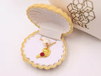 Gold pearl choker necklace with gold sea-animal pendant and red gemstone