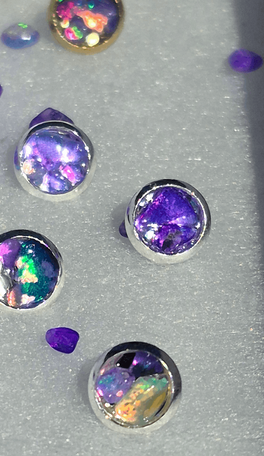 Silver stud earrings with oval Ethiopian purple opal in prong settings