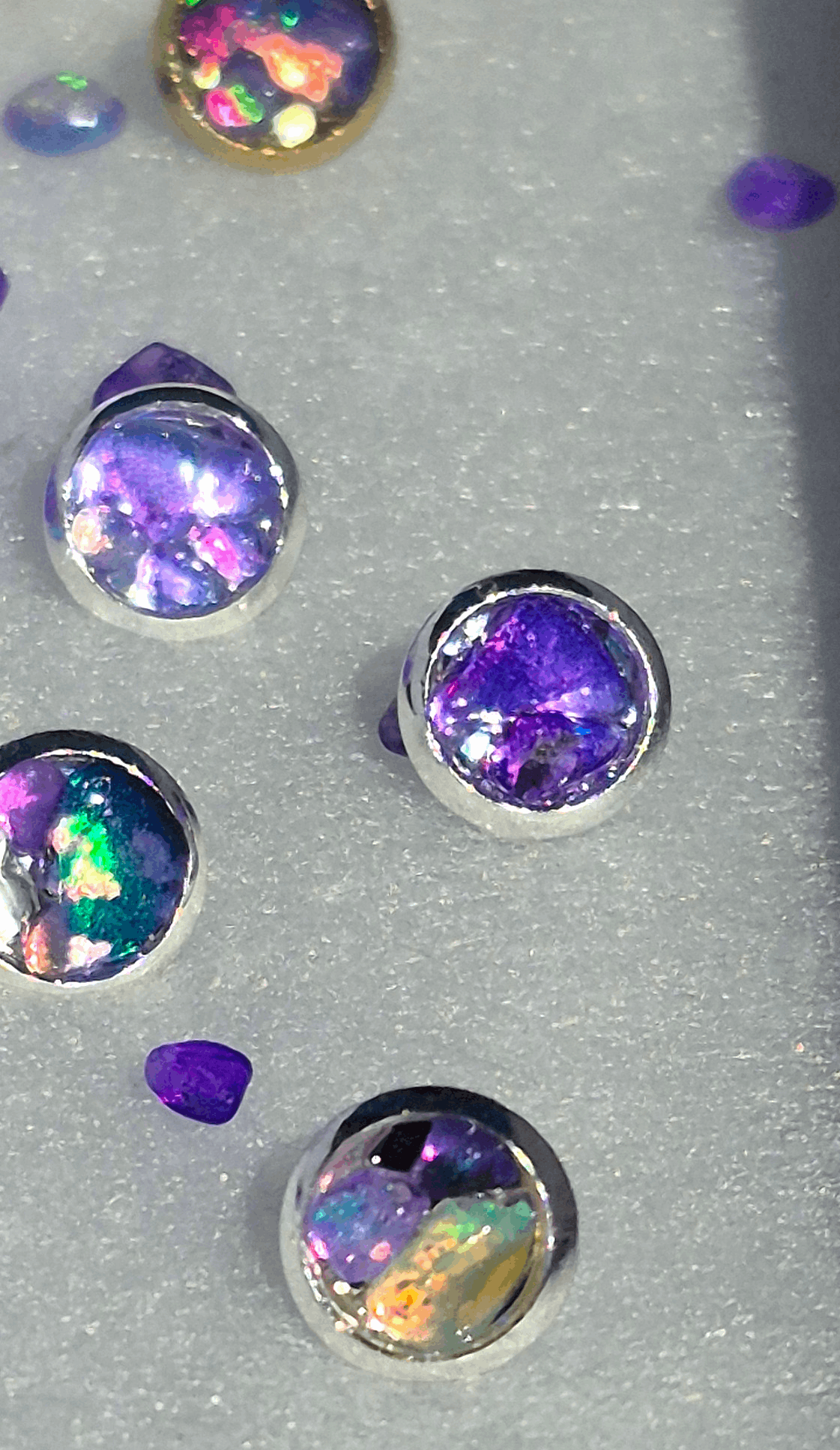Silver stud earrings with oval Ethiopian purple opal in prong settings