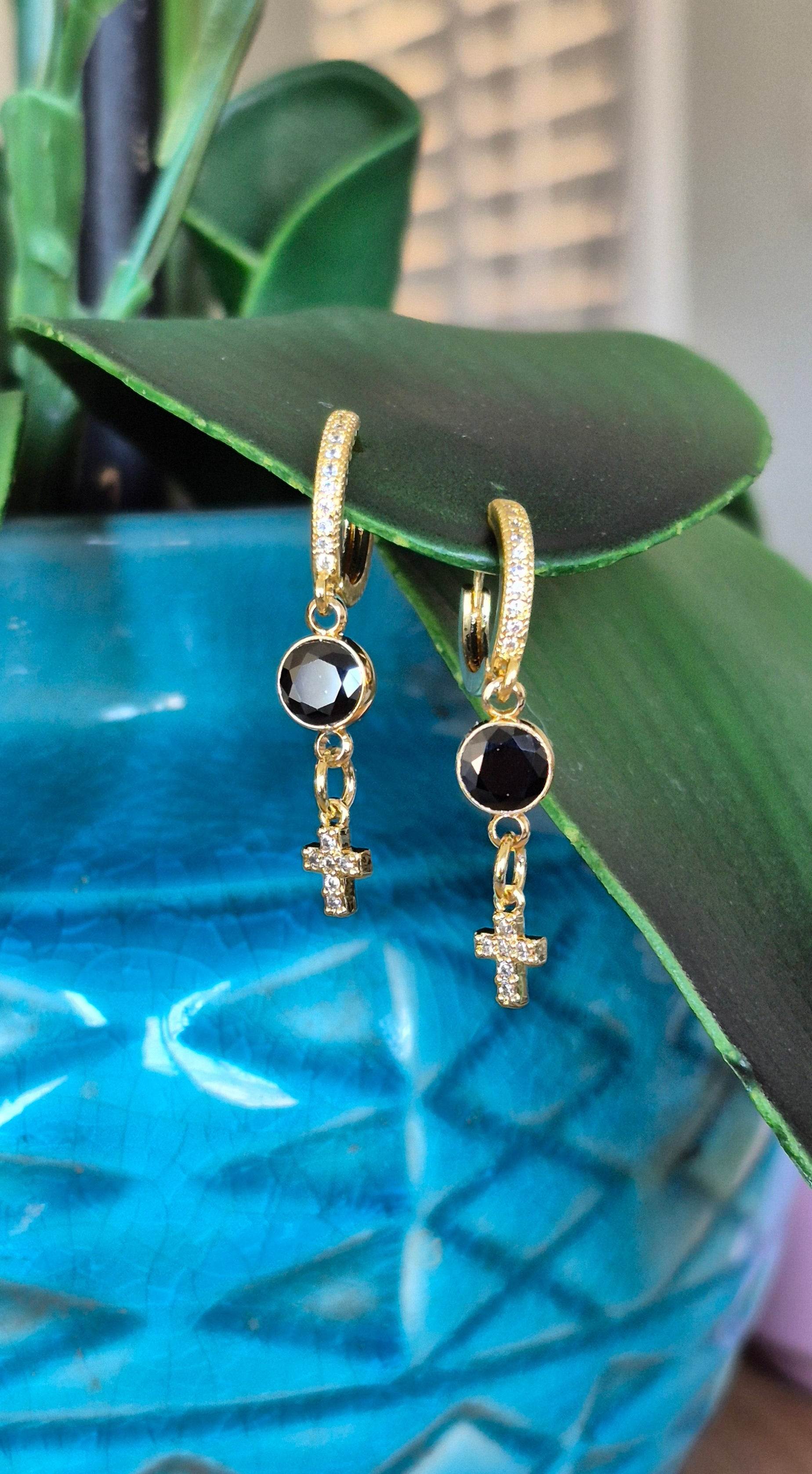 Gold cross huggie hoop earrings with black zircon circles and crystal cross accents