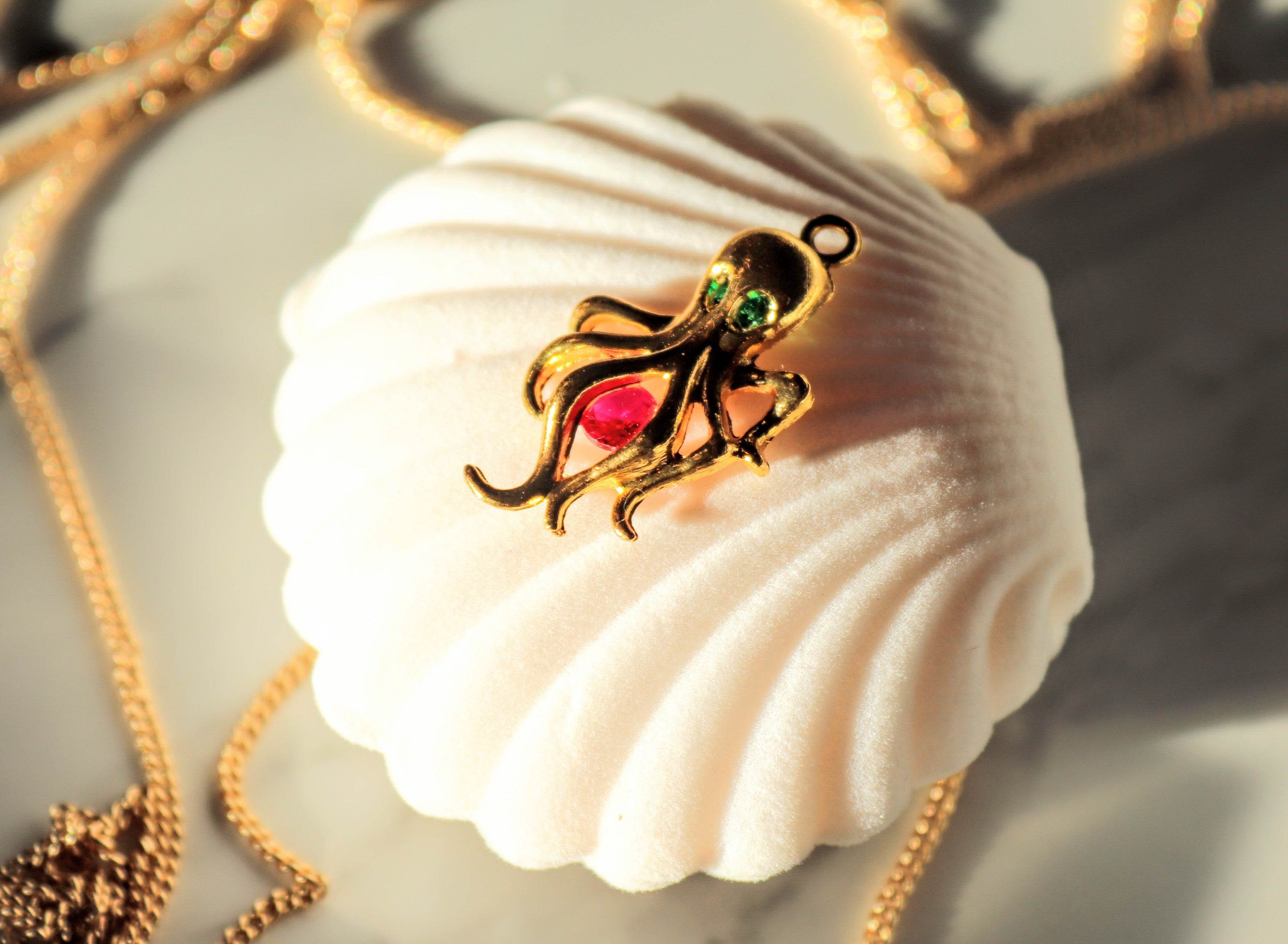 Gold choker necklace with pearl and colorful sea-animal pendant on shell