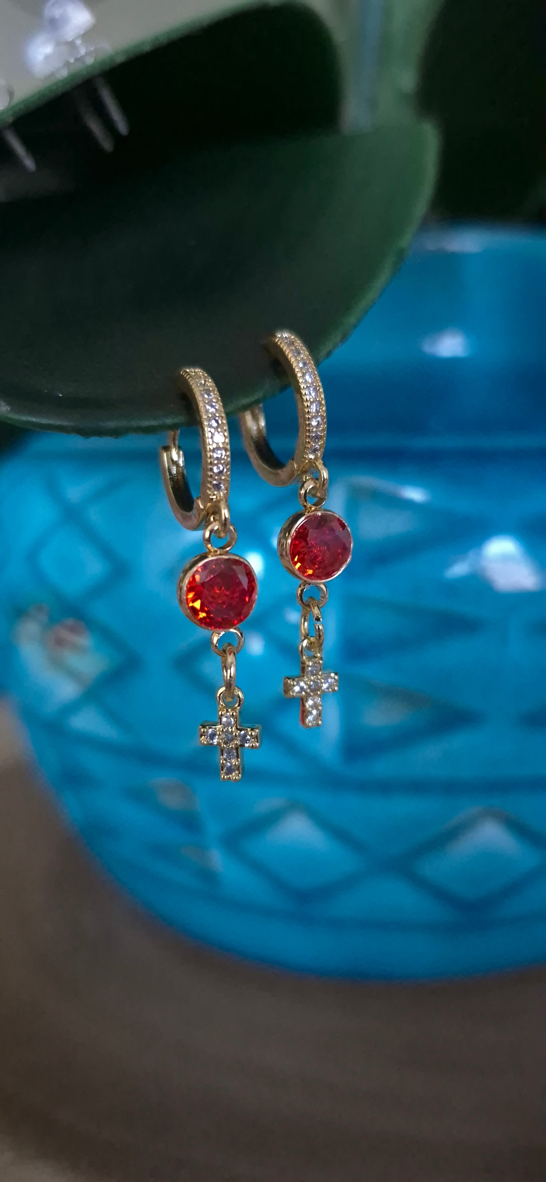 Gold-tone cross drop hoop earrings with red round stones and dangling cross charms