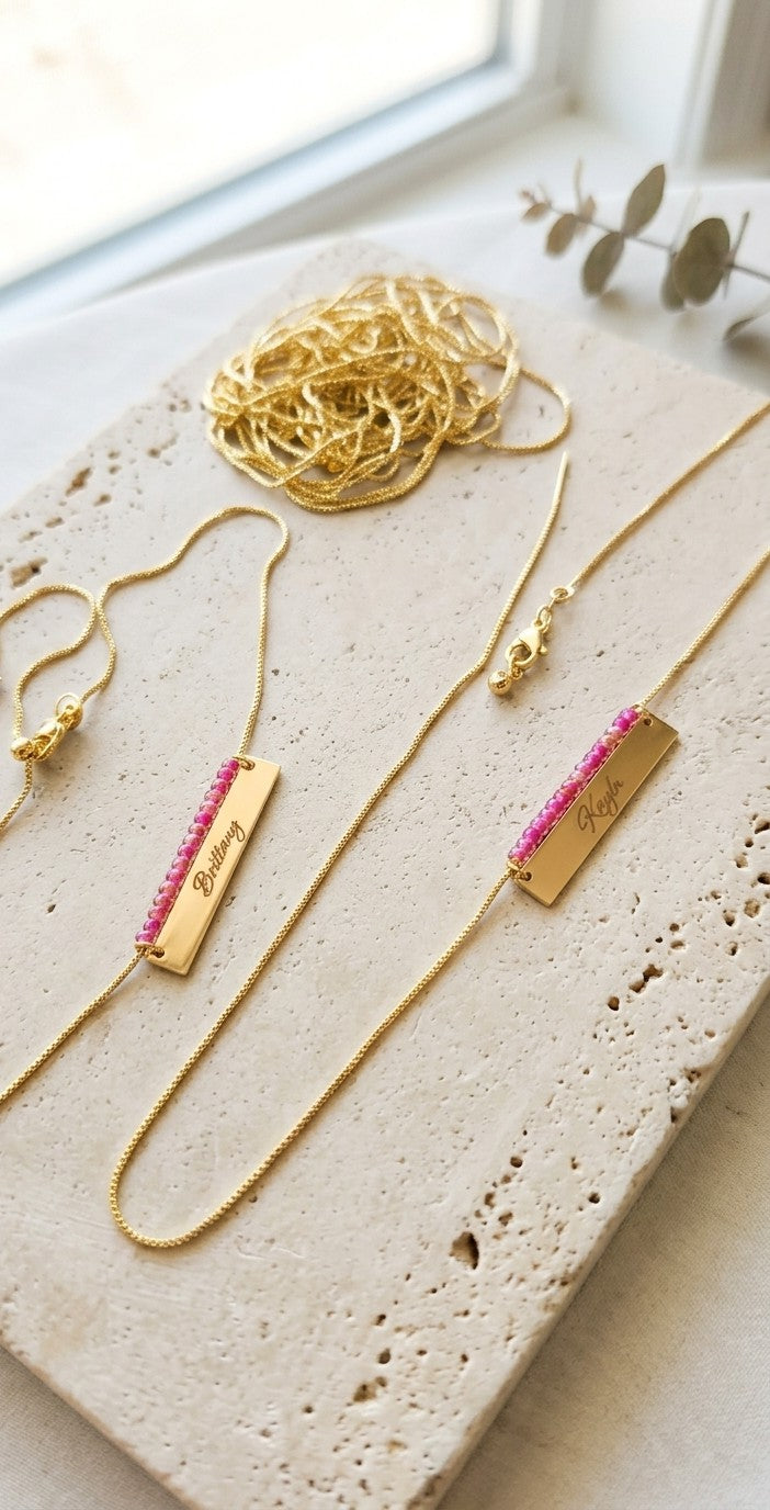 18k gold beaded necklace with engraved nameplate, pink crystal-like beads and gold chain