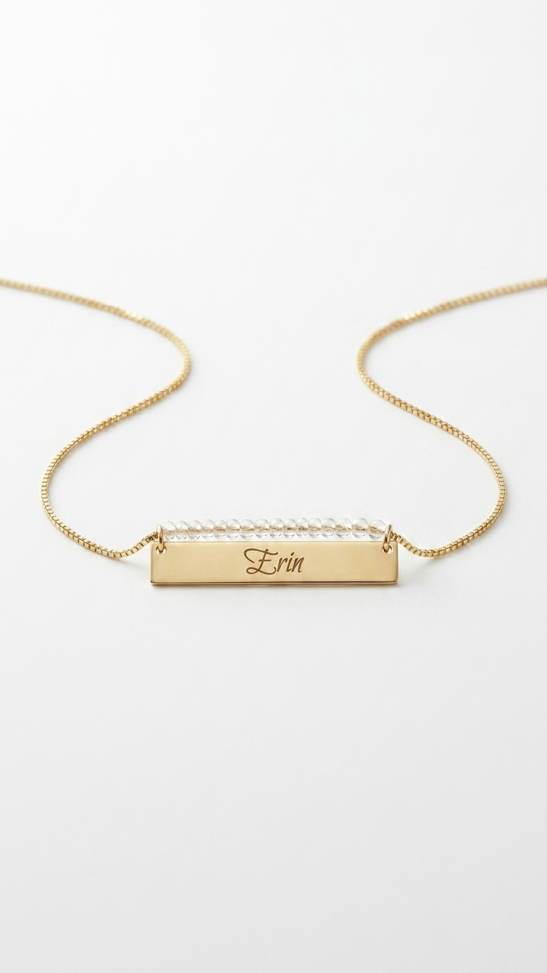 Gold beaded bar name necklace with engraved rectangular nameplate on a short chain